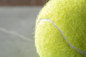tennis ball and racket on court
