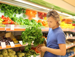 Young man buying vegetables at the market	