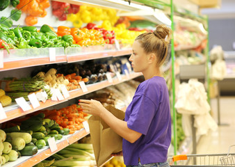 Woman buying vegetables at the market	