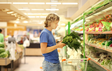 Young man buying vegetables at the market	