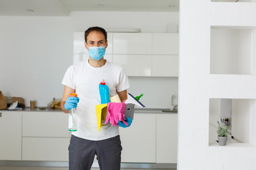 Obraz na płótnie Canvas cleaning, health and hygiene concept - indian man wearing protective medical mask for protection from virus disease in gloves with detergent and mop at home