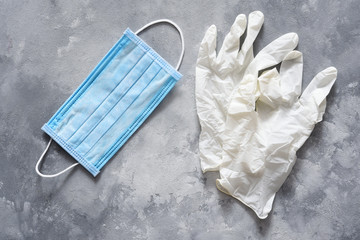 Gloves and mask on a concrete background. Medical accessories.Coronoviris protection.