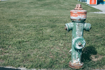 Old green fire hydrant in the city