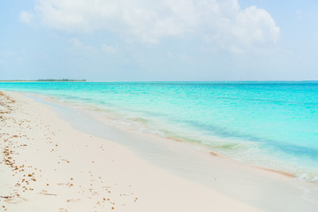 Fototapeta na wymiar Idyllic tropical beach in Caribbean with white sand, turquoise ocean water and blue sky
