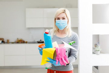 Fototapeta na wymiar Woman cleaning kitchen. Coronavirus prevention and home disinfection.
