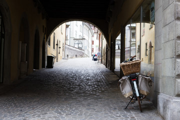 Old european street with paving stones and a bicycle