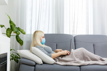 Coronavirus. Young business woman working from home wearing protective mask. Business woman in quarantine for coronavirus wearing protective mask. Working from home.