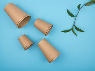 Stylish recyclable paper tableware on a blue background.