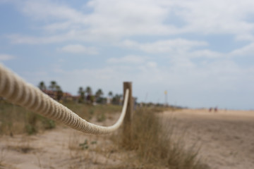 Obraz premium Fabric beige nautical rope on the beach