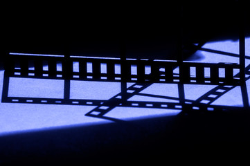Movie background.Film reel stripe cinema on blue and black background with place for text