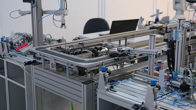 Industry 4.0 smart factory concept; artificial intelligence in production. Close up of Gripper which picks up the product from automated car. Selective focus.
