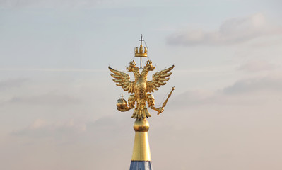 Golden two headed eagle on the top spire of the Moscow Kremlin. The official coat of arms of Russia.