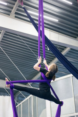 Obraz na płótnie Canvas Young girl doing aerial gymnastics in the gym