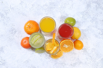Citrus cider, juice, drink and ingredients on a concrete table. The concept of detox diet and weight loss, natural nutrition, increasing the body's immunity against viruses and colds