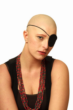 Young bald woman with an eyepatch
