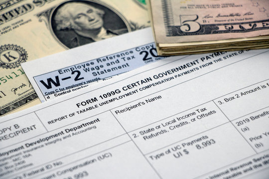 Closeup of Form 1099G for Unemployment Benefits with W2, cash