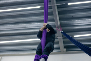 Young girl doing aerial gymnastics in the gym