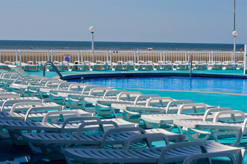 swimming pool in a resort with chairs