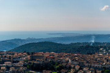 Obraz premium A close-up panoramic view of the old medieval French town Vence with the low Alps mountains hills, the Mediterranean Sea and forests in the background (Provence / Riviera / Côte d'Azur)