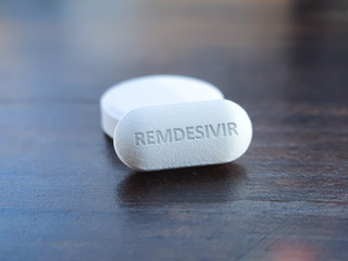 Obraz na płótnie Canvas Concept of tablet for new experimental antiviral drug Remdesivir. Possible cure medication for treatment COVID 19 coronavirus