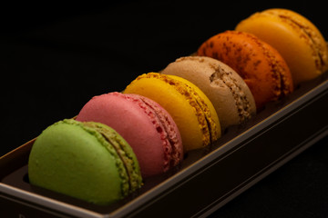 Close up to French Macaroon colors on black background 