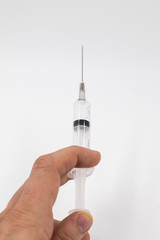 syringe in hand isolated on white background