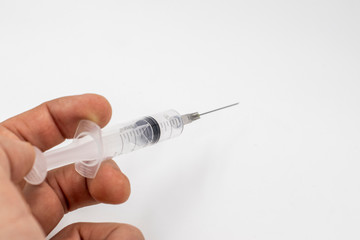 syringe in hand isolated on white background