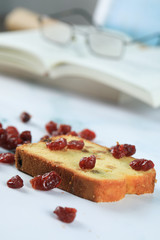 A slice of toast with red berries on a piece of marble