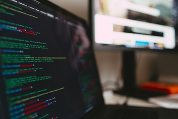 Closeup of computer code on the screen with a blurry background