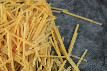Homemade fresh spaghetti on the left side of the background