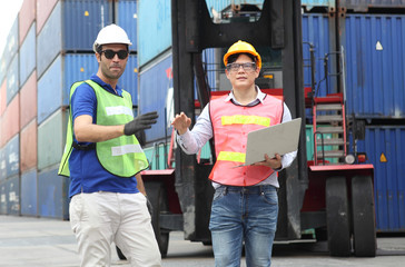Worker inspecting cargo shipping containers. before departure.