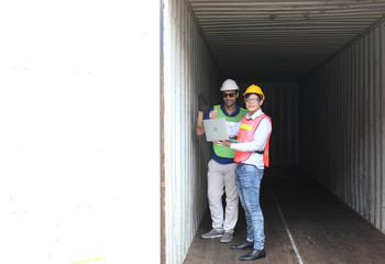 Worker inspecting cargo shipping containers. before departure.