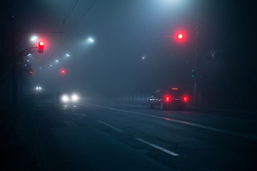 Highway road at night in the fog in the city