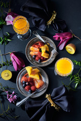 Vivid tropical breakfast served luxury crystal glasses and silver cutlery