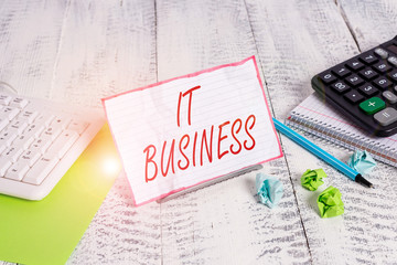 Handwriting text It Business. Conceptual photo organization uses information technology to achieve goals Notepaper stand on buffer wire in between computer keyboard and math sheets