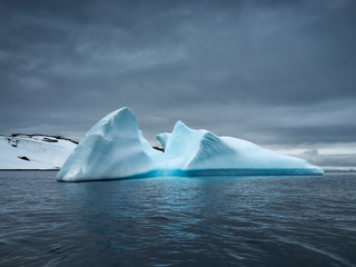 blue iceberg in twilight time with dark clous
