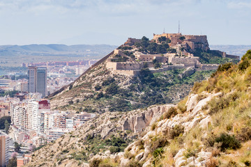 Fototapeta na wymiar Panoramic view of Alicante, Valencian Community, Spain. In the foreground the Castle of Santa Barbara, the Postiguet beach and the port in the background with the city on its shore