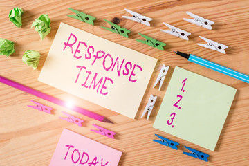 Writing note showing Response Time. Business concept for The amount of time that a demonstrating or system takes to react Colored clothespin papers empty reminder wooden floor background office