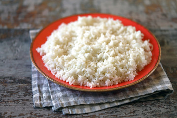 Plate with boiled white rice. Selective focus.