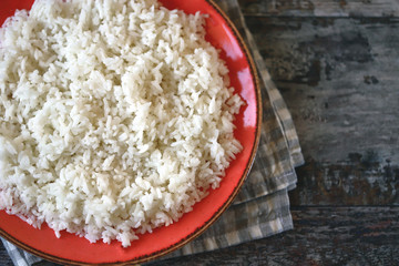 Plate with boiled white rice. Selective focus.