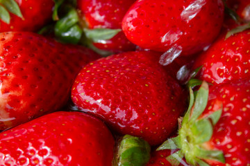 heap of strawberries in water with bubbles