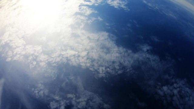 Cloudy Day With Blue Sky And Sun Showing Trough Clouds