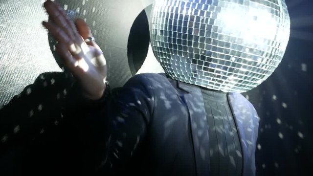 dj dancing with disco ball on his head