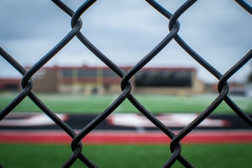 Behind the fence view of football field
