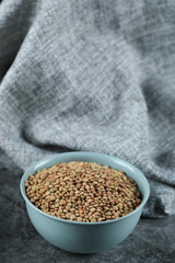 Green fresh and healthy lentil in a blue bowl in the middle