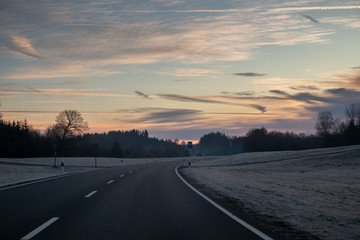 Road through german alps mountains at the sunrise