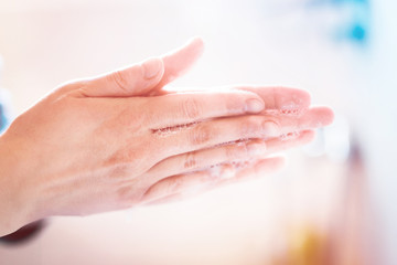 Fototapeta premium Washing hands under running water using soap, important step for a good hygiene