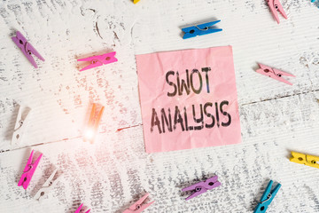Handwriting text Swot Analysis. Conceptual photo framework used to evaluate a company competitive position Colored clothespin rectangle square shaped paper white wood background