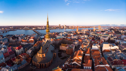 Fototapeta na wymiar Aerial panoramic view to histirical center Riga, quay of river Daugava. Famous Landmark - st. Peter's Church's tower and City Dome Cathedral church, Old Town Monument. Latvia, Europe. shot from drone.