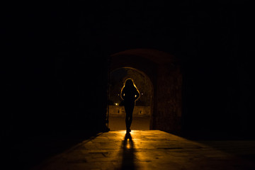 Silhouette of a girl who stands in front of a light source